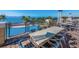 Balcony with outdoor seating overlooking a pool and waterfront for ultimate relaxation and entertaining at 311 Compass Point Dr # 101, Bradenton, FL 34209