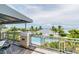 Balcony overlooking a pool and waterfront, offering stunning views and outdoor relaxation at 311 Compass Point Dr # 101, Bradenton, FL 34209