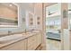 Bathroom with double sinks, granite counters and view to adjacent bedroom at 311 Compass Point Dr # 101, Bradenton, FL 34209
