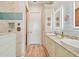 Bathroom boasts double sinks, granite counters, and a modern glass shower with blue accent tiles at 311 Compass Point Dr # 101, Bradenton, FL 34209