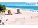 Expansive white sand beach with lifeguard towers and volleyball nets, perfect for recreation and relaxation at 311 Compass Point Dr # 101, Bradenton, FL 34209