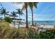 Picturesque beach featuring sugar sand, clear ocean water, swaying palm trees, and inviting hammocks at 311 Compass Point Dr # 101, Bradenton, FL 34209