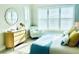 Bright bedroom features plantation shutters, light wood floors, and elegant decor at 311 Compass Point Dr # 101, Bradenton, FL 34209