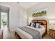 Bedroom featuring modern decor, comfortable bed and view to living area at 311 Compass Point Dr # 101, Bradenton, FL 34209