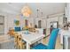 Open-concept dining room with elegant lighting, flows to living and kitchen area at 311 Compass Point Dr # 101, Bradenton, FL 34209