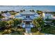 Beautiful waterfront home showcasing lush landscaping, a symmetrical facade, and a charming entrance at 311 Compass Point Dr # 101, Bradenton, FL 34209
