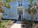 Beautiful front entrance of a home with a well-maintained lawn and attractive landscaping at 311 Compass Point Dr # 101, Bradenton, FL 34209