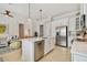 Open-concept kitchen and living area with white cabinets and stainless steel appliances at 311 Compass Point Dr # 101, Bradenton, FL 34209