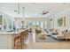 Bright, open-concept living room featuring a modern kitchen, dining area, and comfortable seating at 311 Compass Point Dr # 101, Bradenton, FL 34209