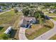 Aerial view of a white single-Gathering home with a dark roof, large yard and in-ground pool at 3239 Daytona Dr, Punta Gorda, FL 33983