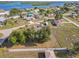 Aerial view of a lovely home featuring mature trees, a screened pool, and a spacious yard near a waterfront community at 3239 Daytona Dr, Punta Gorda, FL 33983