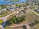 Overhead view displaying mature trees, a screened pool, the expansive yard, and the home's desirable location within a waterfront community at 3239 Daytona Dr, Punta Gorda, FL 33983