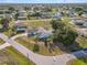 Aerial view of a white single-Gathering home with a dark roof, large yard, long driveway and in-ground pool at 3239 Daytona Dr, Punta Gorda, FL 33983