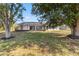 View of the rear of the house, a screened lanai, and grassy backyard at 3239 Daytona Dr, Punta Gorda, FL 33983