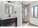Modern bathroom with black fixtures, walk-in shower, floating vanity, and recessed lighting at 3239 Daytona Dr, Punta Gorda, FL 33983