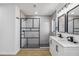 Stylish bathroom with a double vanity, sleek black fixtures, modern shower, and contemporary tile work at 3239 Daytona Dr, Punta Gorda, FL 33983
