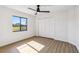 Minimalist bedroom featuring a window, closet, and light-colored wood-look flooring at 3239 Daytona Dr, Punta Gorda, FL 33983