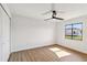 Cozy bedroom featuring a ceiling fan, wood floors and a window at 3239 Daytona Dr, Punta Gorda, FL 33983