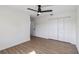 A bright bedroom featuring modern ceiling fan, light wood floors, closet and painted in neutral colors at 3239 Daytona Dr, Punta Gorda, FL 33983