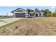 Charming single story house with gray garage and front yard at 3239 Daytona Dr, Punta Gorda, FL 33983
