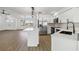 Modern kitchen with white cabinetry, stainless steel appliances, quartz countertops, and an island with breakfast bar at 3239 Daytona Dr, Punta Gorda, FL 33983