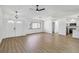 Spacious living room showcasing wood-look flooring, modern lighting, and an open layout, perfect for gatherings at 3239 Daytona Dr, Punta Gorda, FL 33983