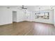 Open-concept living room boasts contemporary lighting fixtures, wood-look flooring, and ample natural light at 3239 Daytona Dr, Punta Gorda, FL 33983
