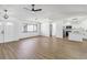 Well-lit living room features wood-look flooring, modern fixtures, white walls, and seamless kitchen access at 3239 Daytona Dr, Punta Gorda, FL 33983