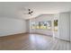 Bright living room featuring a ceiling fan and large windows at 3239 Daytona Dr, Punta Gorda, FL 33983