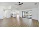 Open-concept living room seamlessly connects to the kitchen, featuring wood-look floors and modern lighting at 3239 Daytona Dr, Punta Gorda, FL 33983