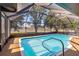 Pool with screened enclosure, patio area and access steps at 3239 Daytona Dr, Punta Gorda, FL 33983