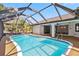 Inviting screened-in pool with clear blue water, offering a perfect oasis for relaxation and entertainment at 3239 Daytona Dr, Punta Gorda, FL 33983