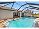 Pool with screened enclosure attached to the back of the home at 3239 Daytona Dr, Punta Gorda, FL 33983