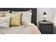 Close up of a decorated primary bedroom with a queen bed, pillows, whale pillow, and a side table with a lamp at 3303 32Nd W St, Bradenton, FL 34205