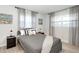 Nicely staged bedroom features a queen bed, two windows, side tables with lamps, and boat themed artwork at 3303 32Nd W St, Bradenton, FL 34205