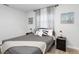 Calm bedroom with soft gray bedding, modern nightstands, and nautical-themed artwork at 3303 32Nd W St, Bradenton, FL 34205