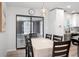 Bright dining room with seating, modern light fixture, and kitchen access at 3303 32Nd W St, Bradenton, FL 34205