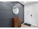 Stylish entryway featuring decorative wall paneling, modern mirror, and white front door at 3303 32Nd W St, Bradenton, FL 34205