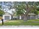 Charming single-story home with brick facade, mature shade tree, and attached garage at 3303 32Nd W St, Bradenton, FL 34205