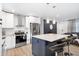 Modern kitchen with stainless appliances, granite countertops, island with barstools, and accent lighting at 3303 32Nd W St, Bradenton, FL 34205