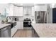 Modern kitchen featuring white cabinets, stainless steel appliances, granite countertops, and black sink at 3303 32Nd W St, Bradenton, FL 34205