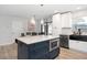 Modern kitchen featuring island with seating, stainless steel appliances, and granite countertops at 3303 32Nd W St, Bradenton, FL 34205