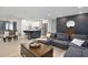 Open-concept living room with view of kitchen, island with seating, and stylish decor at 3303 32Nd W St, Bradenton, FL 34205