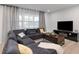 Comfortable living room with a large sectional sofa, stylish curtains, and a flat-screen TV at 3303 32Nd W St, Bradenton, FL 34205
