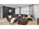 Spacious living room with large sectional sofa, modern decor, and hardwood floors at 3303 32Nd W St, Bradenton, FL 34205