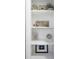 Detail of built-in shelves with seaside decor, and coastal themed artwork adding a decorative accent at 3303 32Nd W St, Bradenton, FL 34205