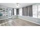 Bright and airy sunroom with light gray walls and large windows, and plank floors at 3303 32Nd W St, Bradenton, FL 34205