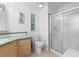 Clean bathroom with tiled floor, glass shower, and green-accented vanity with sink at 3352 Laurel Oak Way, Sarasota, FL 34237