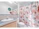 Bathroom with a vanity, toilet, mirror and shower tub with a sea themed shower curtain at 3352 Laurel Oak Way, Sarasota, FL 34237
