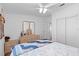 Bright bedroom features natural wood furniture, ceiling fan and a comfortable bed with colorful quilt at 3352 Laurel Oak Way, Sarasota, FL 34237